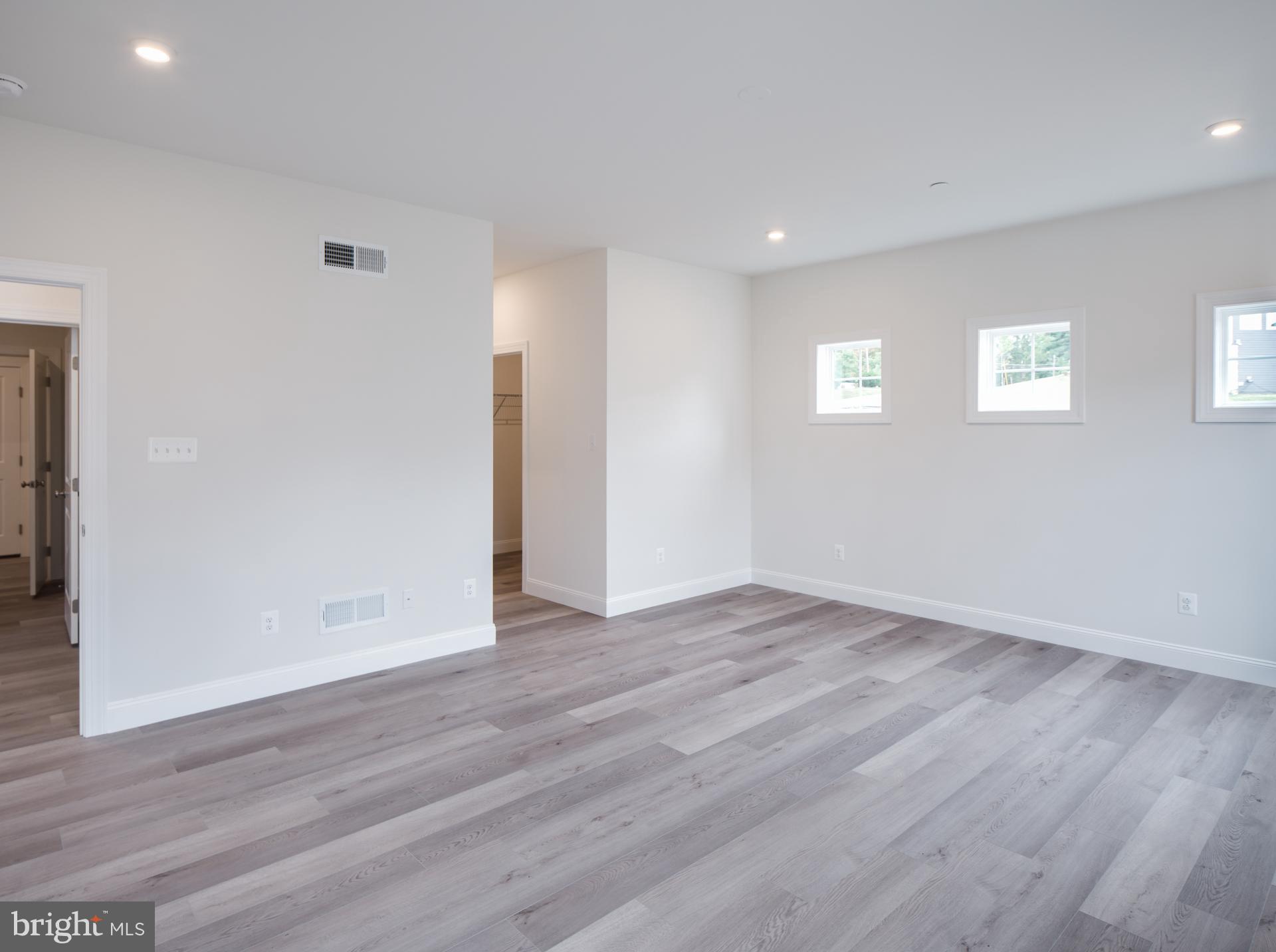 8528 Rocky Springs Road Frederick, MD 21702 - Photo 27 of 93 a view of an empty room with wooden floor and a window