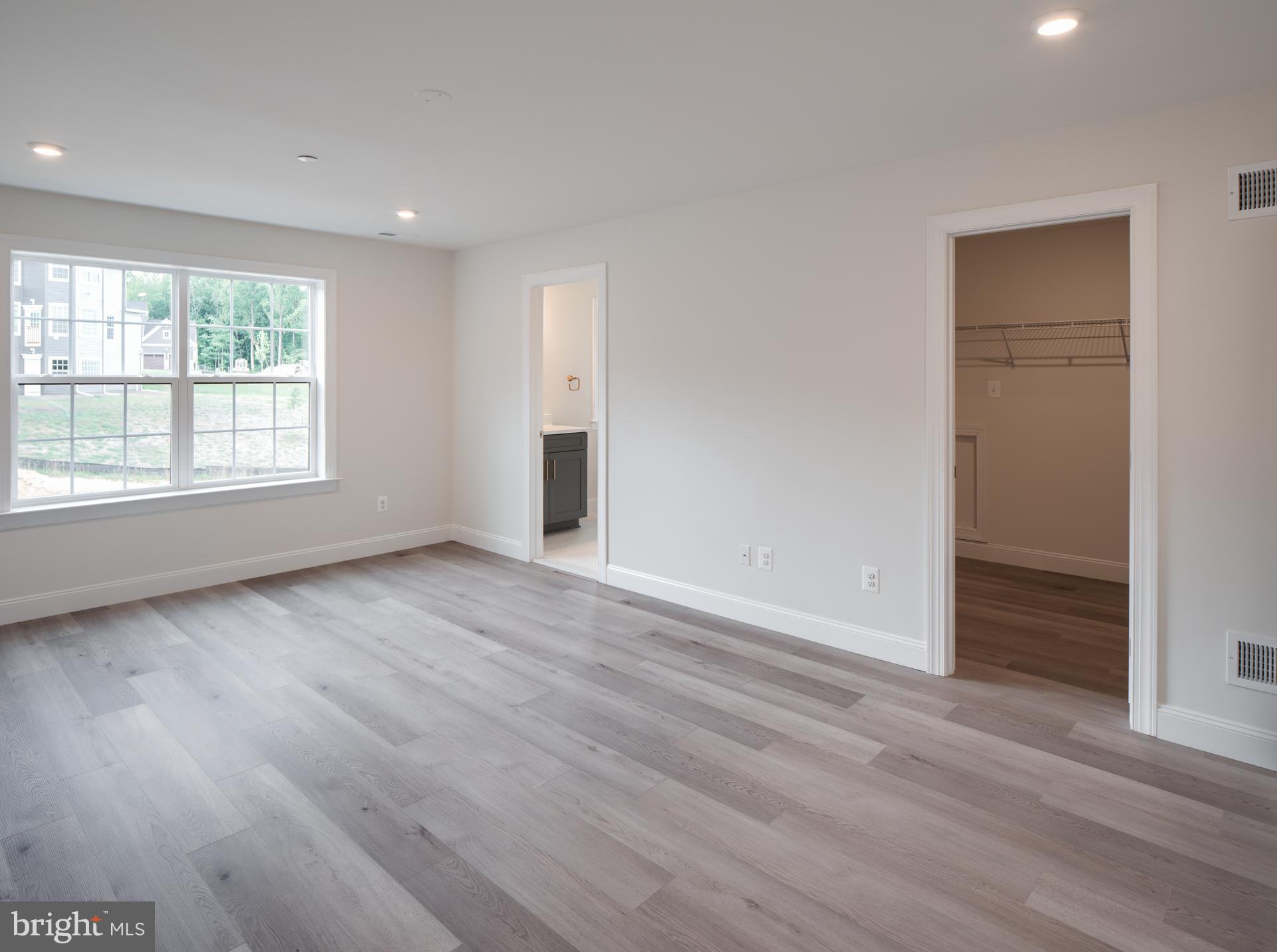 8528 Rocky Springs Road Frederick, MD 21702 - Photo 36 of 93 an empty room with wooden floor and windows