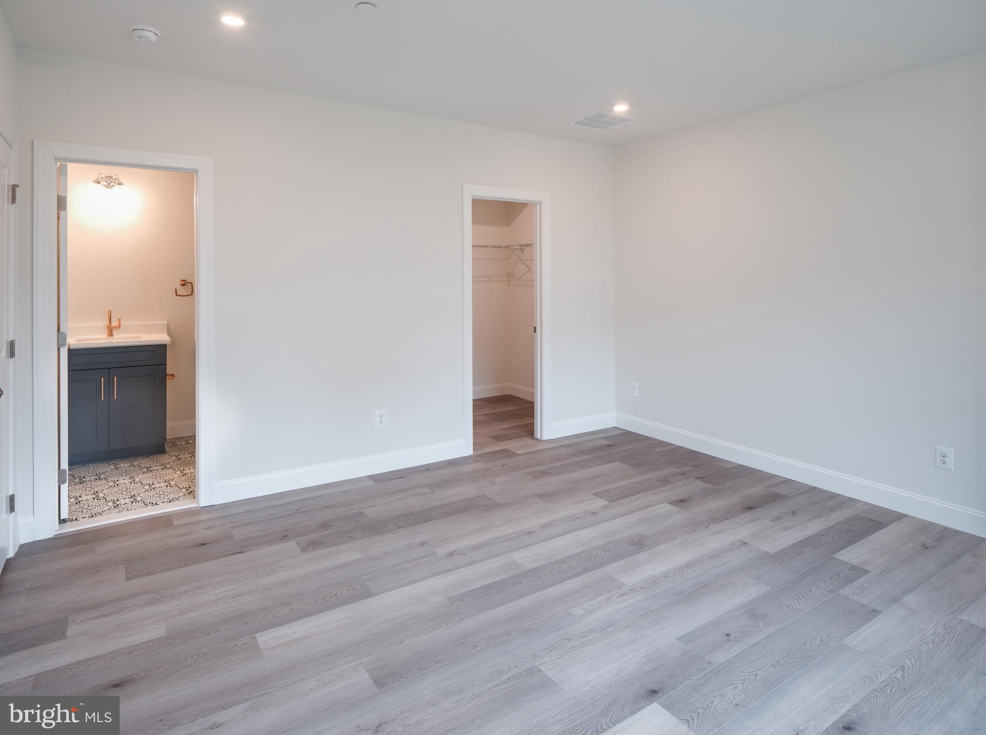 8528 Rocky Springs Road Frederick, MD 21702 - Photo 45 of 93 a view of an empty room with wooden floor and closet