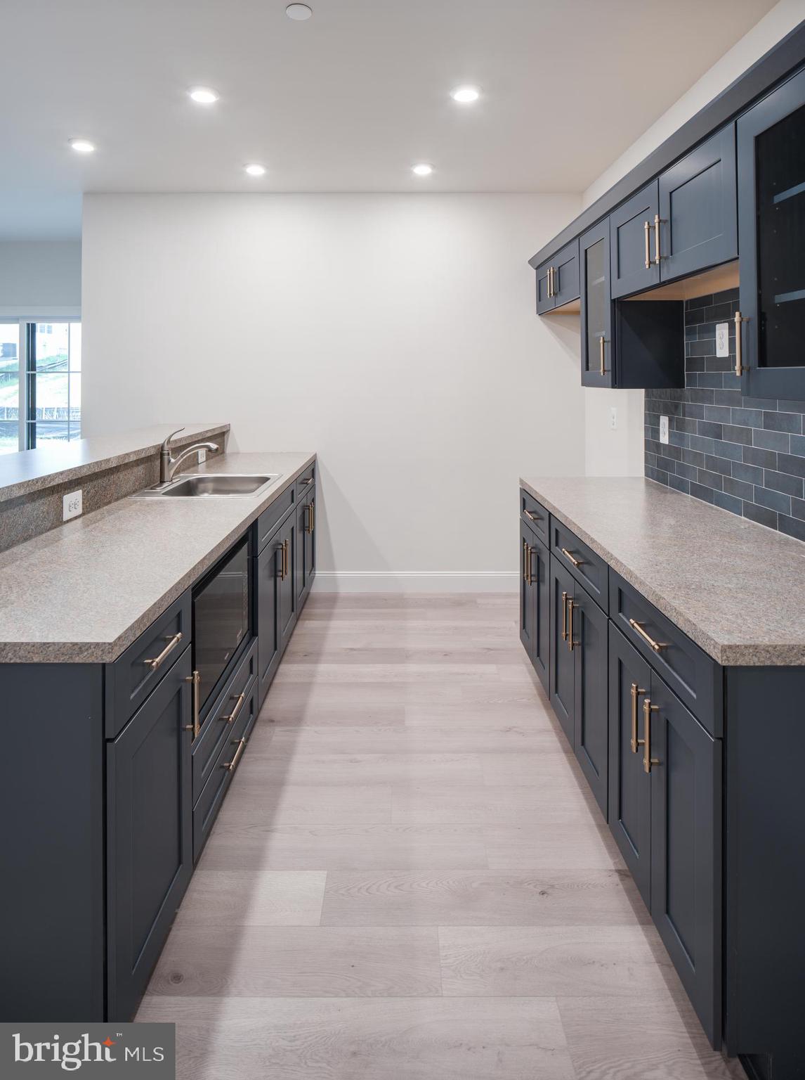 8528 Rocky Springs Road Frederick, MD 21702 - Photo 47 of 93 a kitchen with stainless steel appliances granite countertop a sink and a wooden floors