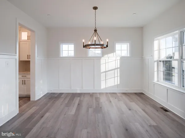 a view of a kitchen with white cabinets