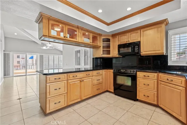 a kitchen with granite countertop a stove a sink and a cabinets