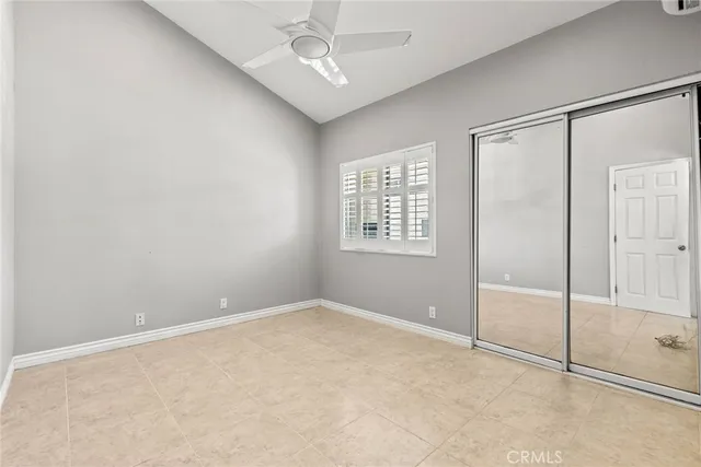 an empty room with windows and closet