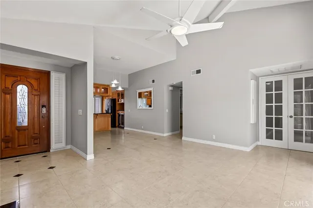 an empty room with closet and a ceiling fan