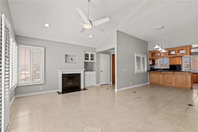 a view of a livingroom with an empty space and a fireplace