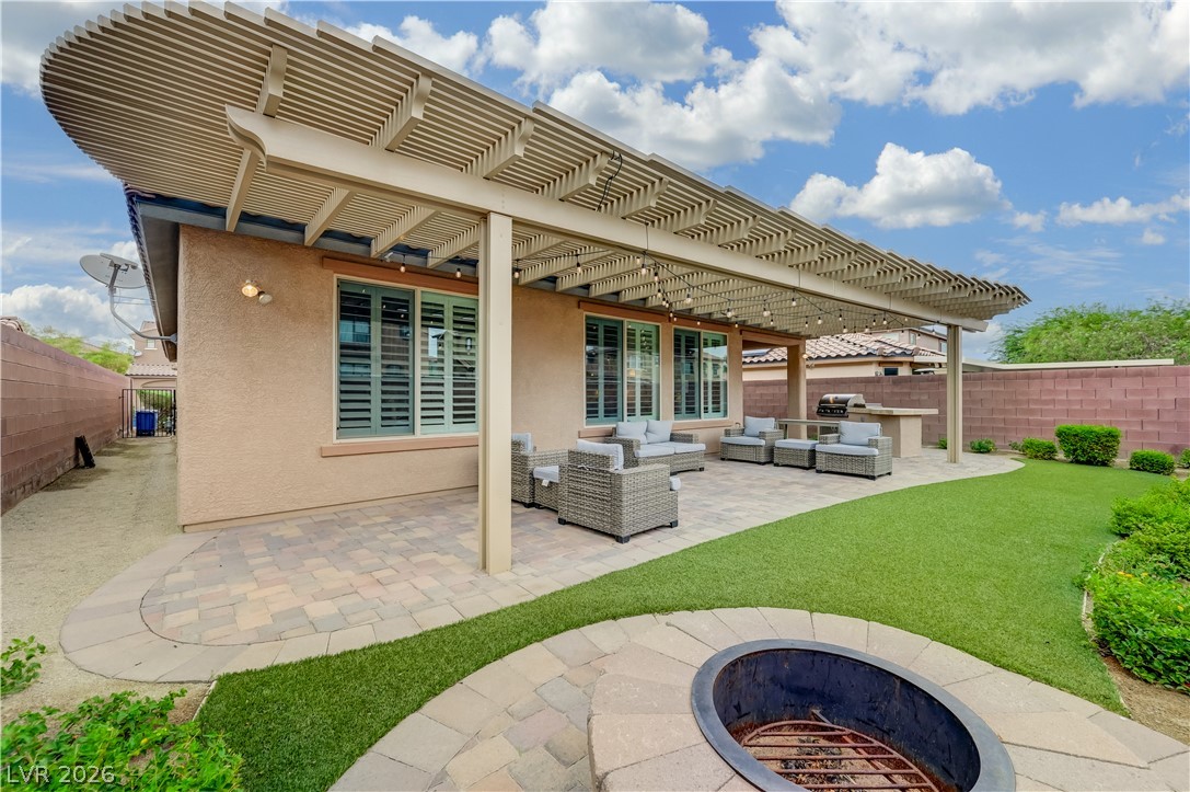 7049 Motley Road Las Vegas, NV 89178 - Photo 53 of 61 An expansive covered patio features integrated pavers and transitions smoothly into the manicured yard.