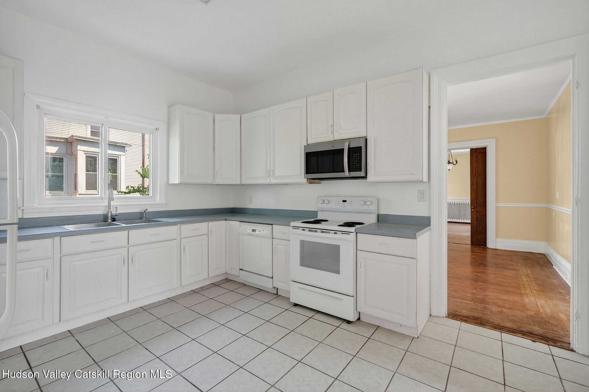 17 New Street Catskill, NY 12414 - Photo 17 of 92 a kitchen with cabinets appliances and a window