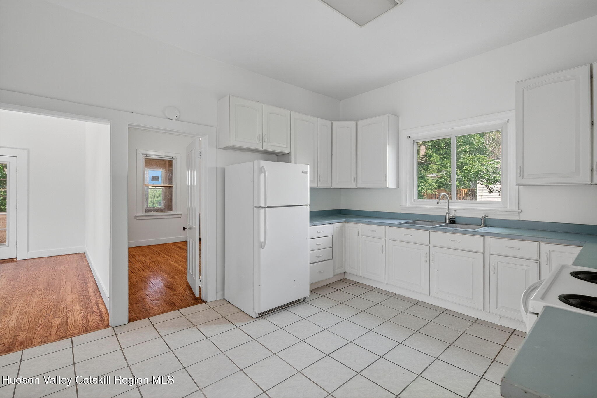 17 New Street Catskill, NY 12414 - Photo 19 of 92 a kitchen with white cabinets and white appliances