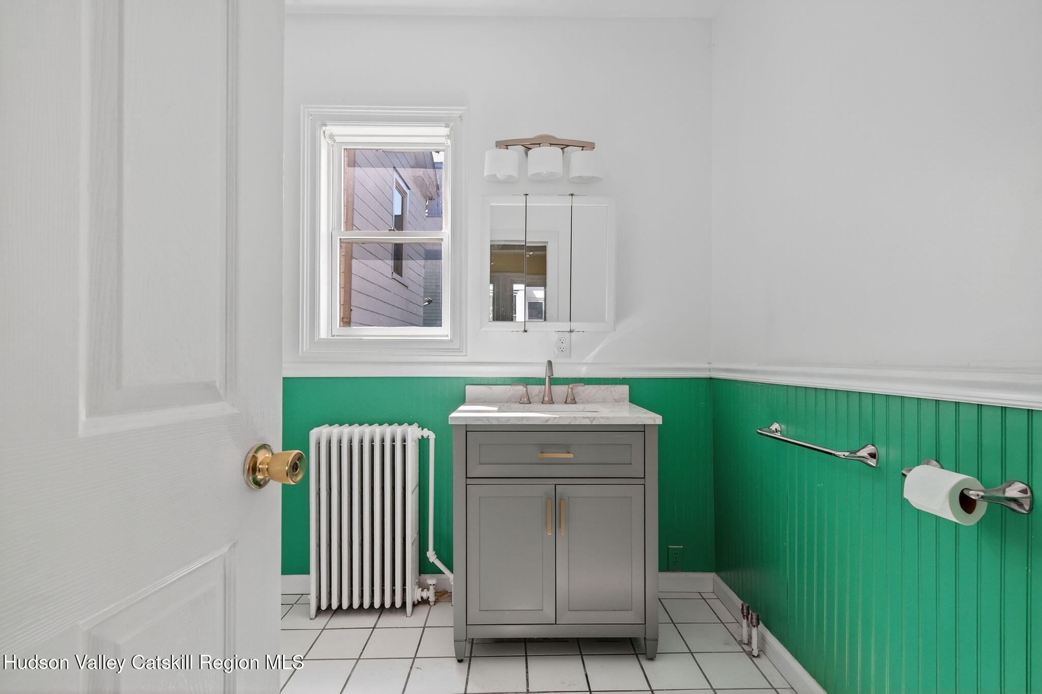 17 New Street Catskill, NY 12414 - Photo 20 of 92 a bathroom with a sink and mirror