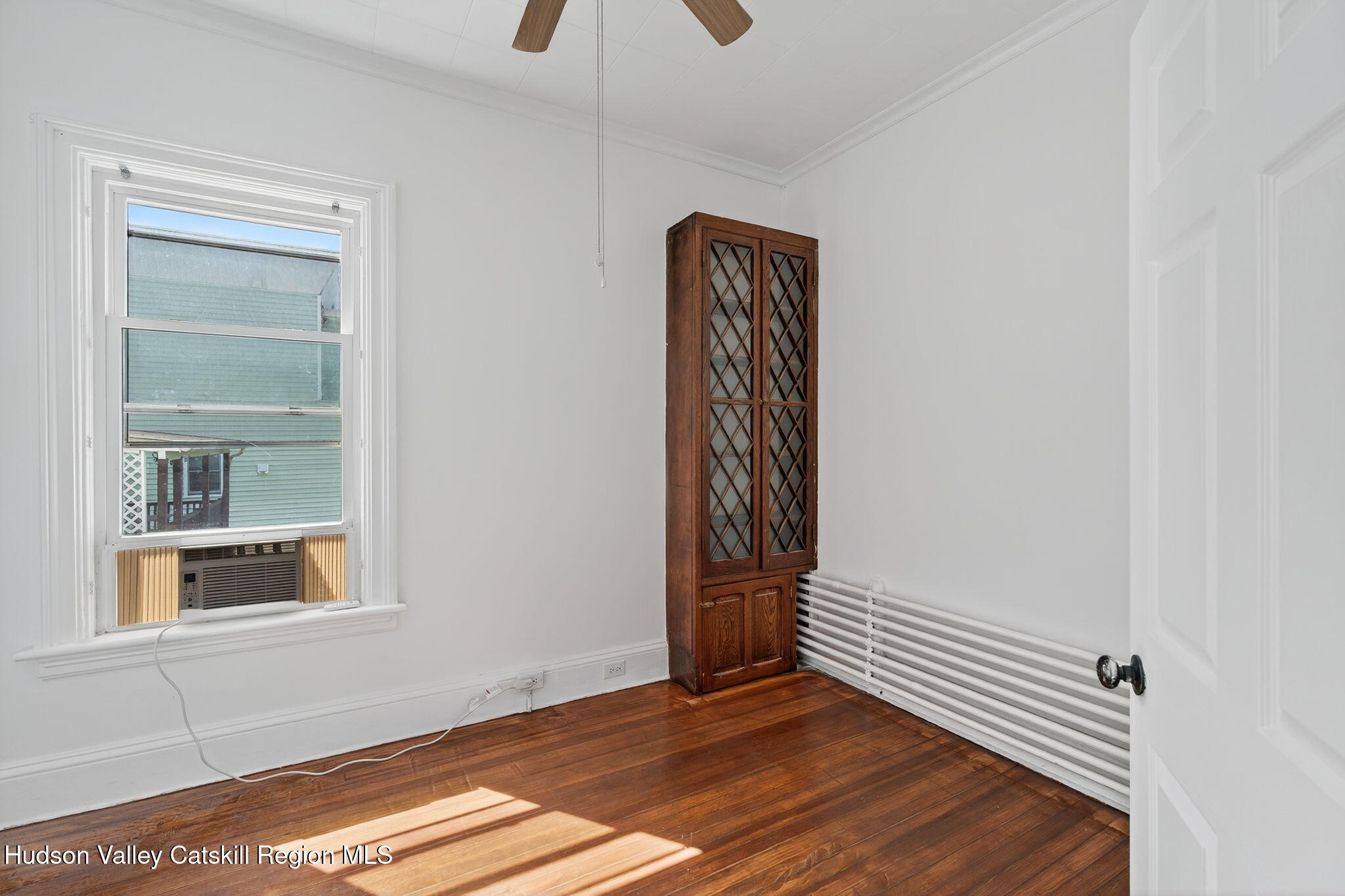 17 New Street Catskill, NY 12414 - Photo 27 of 92 a view of an empty room with a window and wooden floor