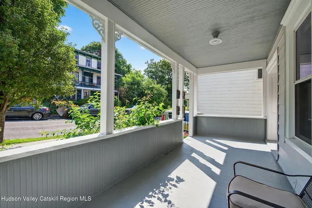 a view of entryway with wooden floor and stairs