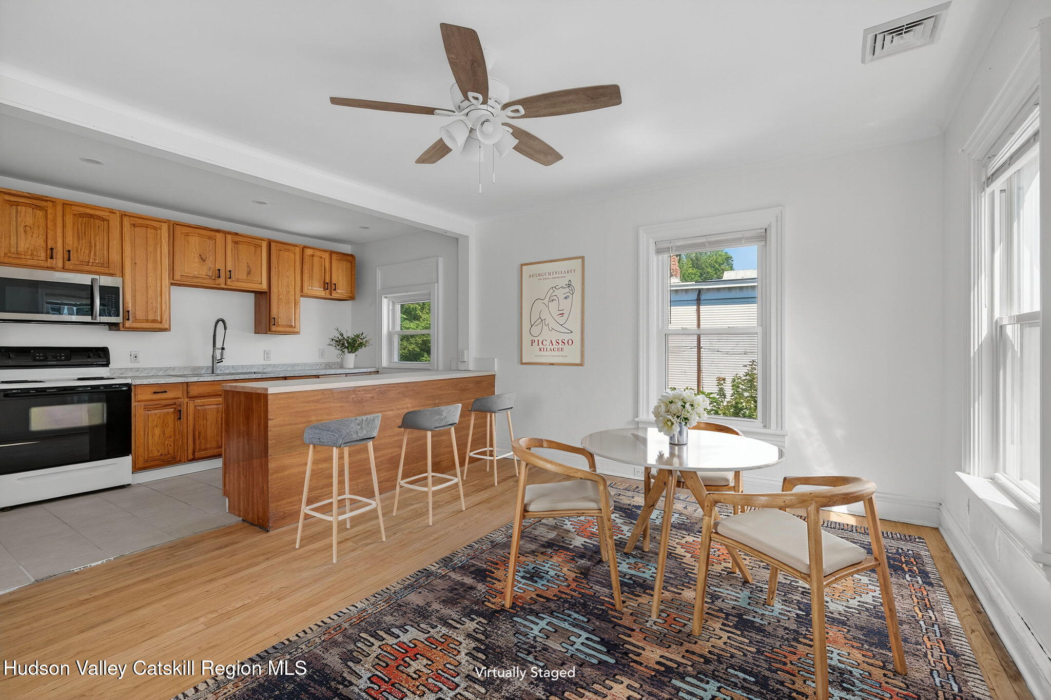 17 New Street Catskill, NY 12414 - Photo 41 of 92 a kitchen with a dining table chairs and granite counter tops
