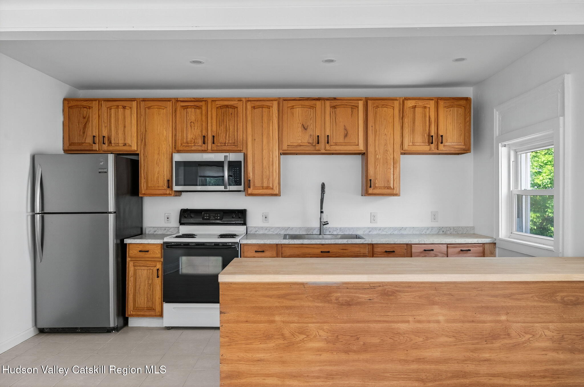 17 New Street Catskill, NY 12414 - Photo 43 of 92 a kitchen with stainless steel appliances granite countertop a refrigerator a stove a sink and a microwave