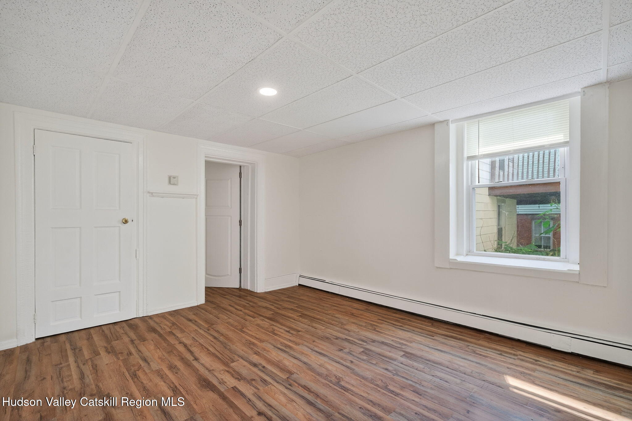 17 New Street Catskill, NY 12414 - Photo 72 of 92 a view of empty room with wooden floor and fan