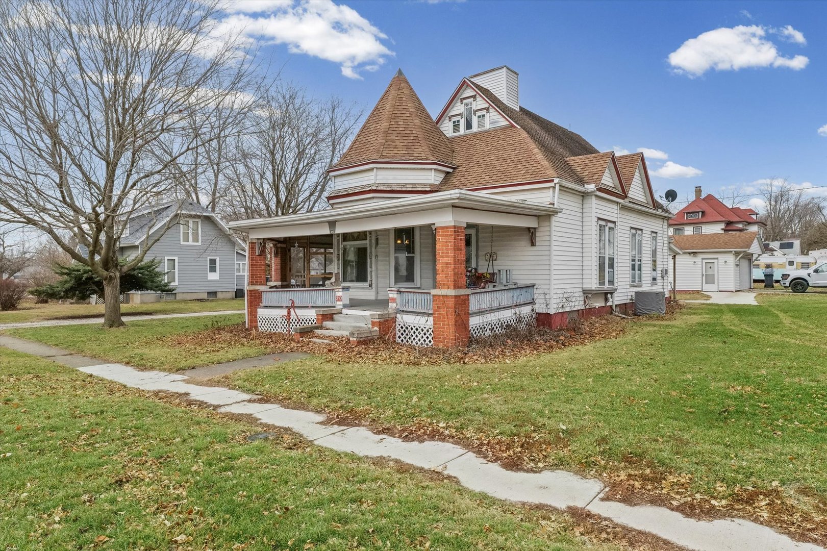 310 North Main Street Homer, IL 61849 - Photo 1 of 25 a view of a white house next to a yard with big trees