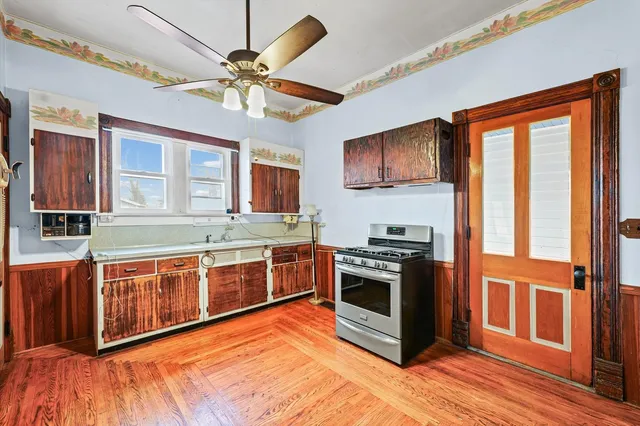 a large kitchen with stainless steel appliances granite countertop a stove and a sink
