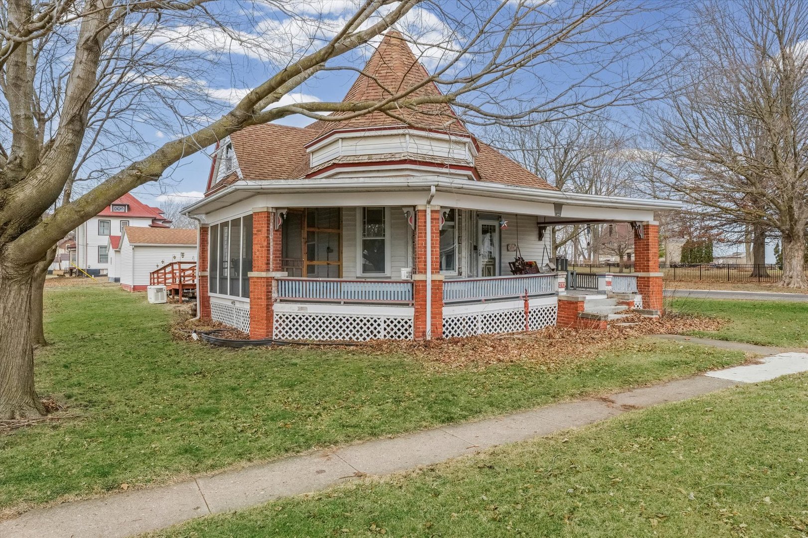 310 North Main Street Homer, IL 61849 - Photo 3 of 25 a view of a white house with a big yard and large tree