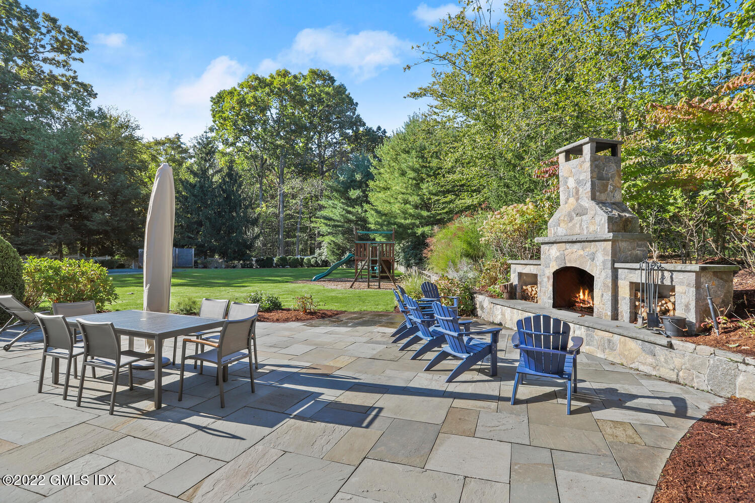 434 Cognewaugh Road Cos Cob, CT 06807 - Photo 39 of 47 a view of a patio with a table chairs and a fire pit