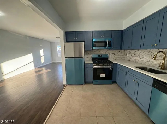 a kitchen with stainless steel appliances granite countertop a refrigerator stove a sink and dishwasher