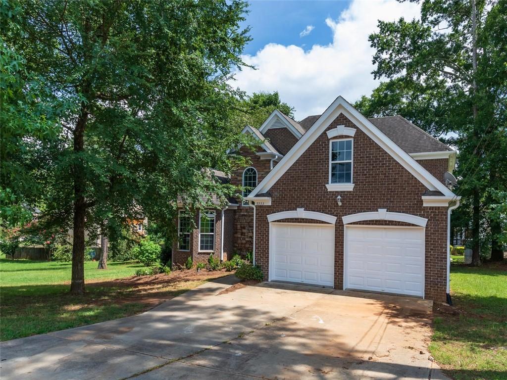 5533 Flat Shoals Parkway Decatur, GA 30034 - Photo 1 of 1 a view of a house with a yard plants and large tree