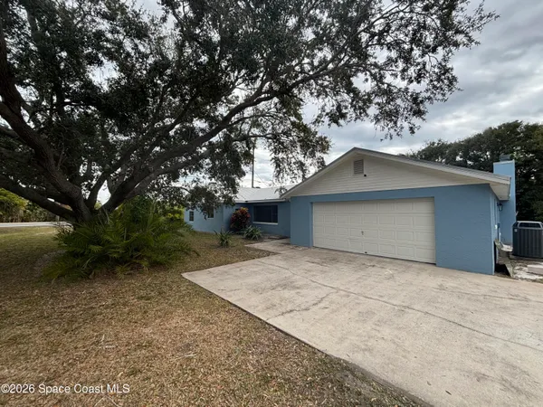 a house with trees in the background