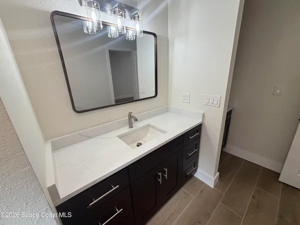 a spacious bathroom with a double vanity sink and a mirror