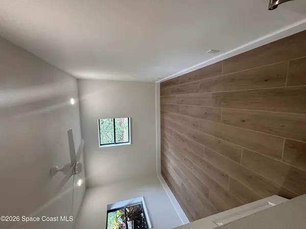 a view of hallway with window and stairs