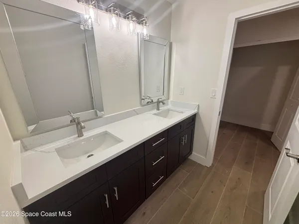 a bathroom with a double vanity sink a and mirror