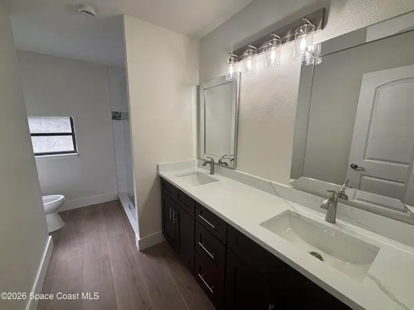 a bathroom with a double vanity sink and a mirror