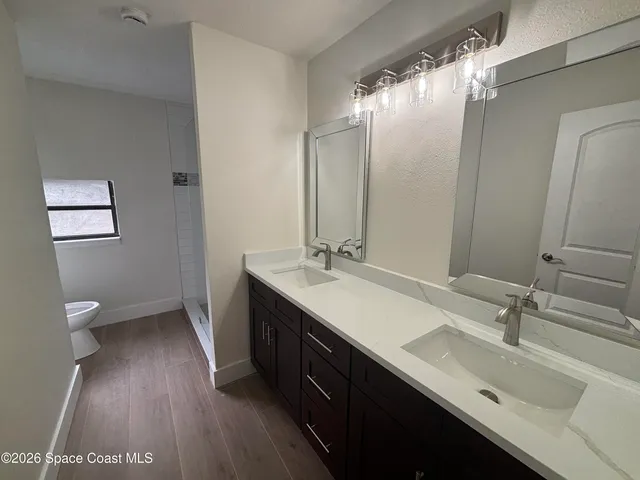 a bathroom with a double vanity sink and a mirror