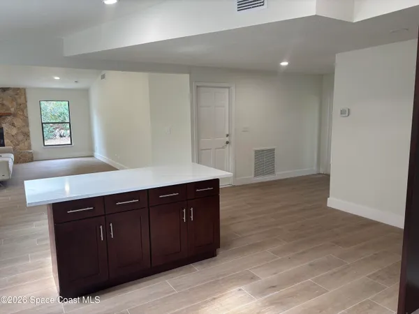 a spacious bathroom with a sink and a mirror