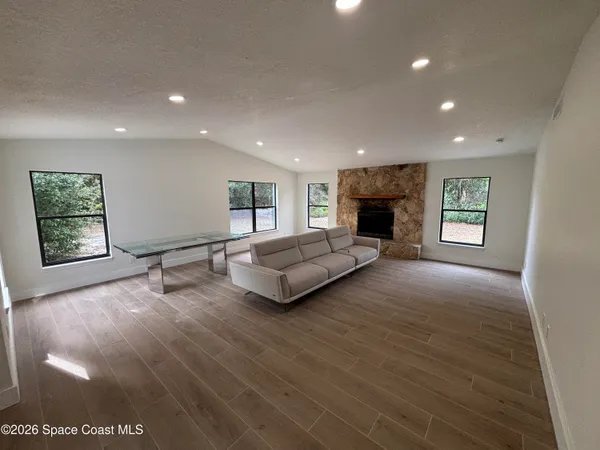a living room with fireplace furniture and a window