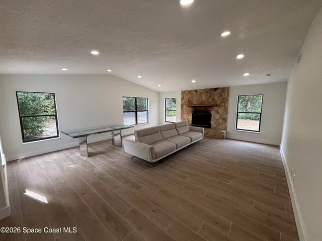 a living room with fireplace furniture and a window