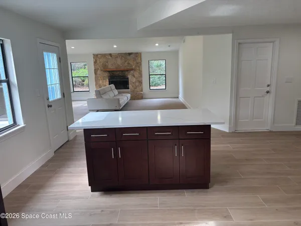 a kitchen with a granite countertop sink and cabinets