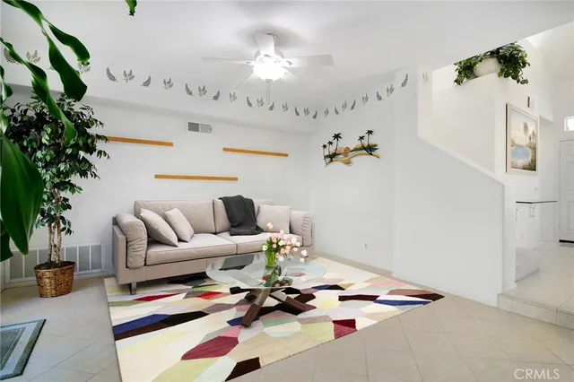 a living room with furniture flowers and a chandelier