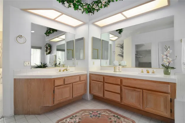 a spacious bathroom with a double vanity sink mirror and