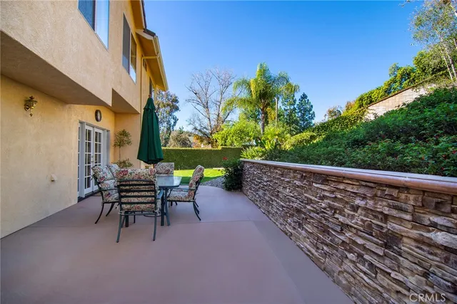 a balcony with table and chairs