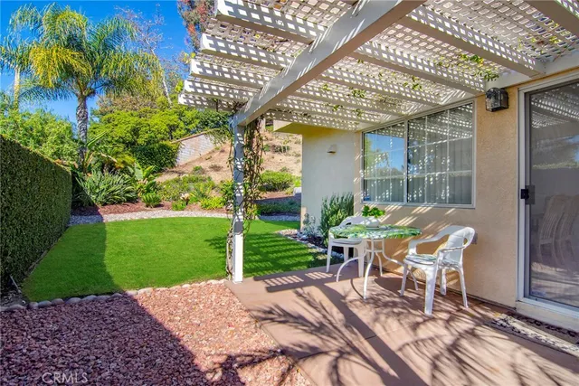 a view of a patio with a table and chairs
