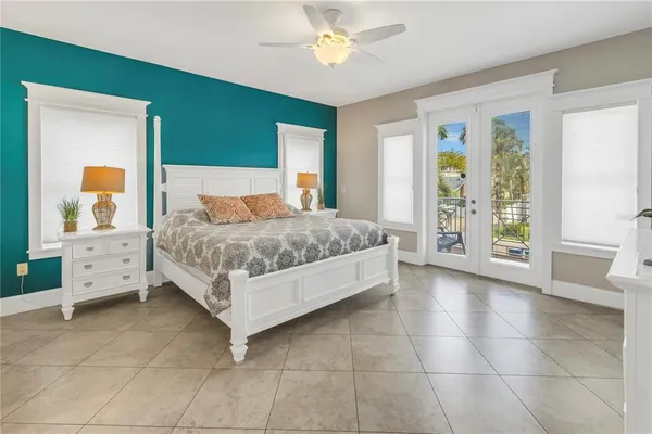 a living room with a bed and a chandelier
