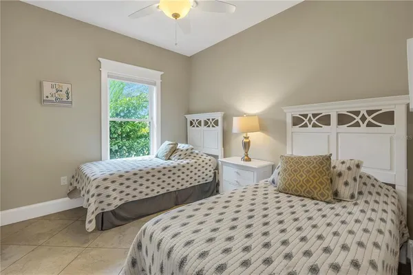 a bedroom with two beds and a window
