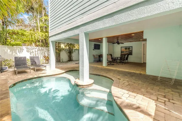 a swimming pool with patio outdoor seating and yard