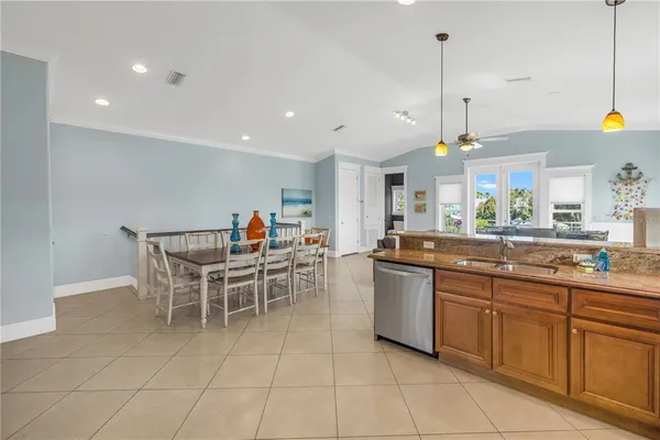 a kitchen with a sink and chairs