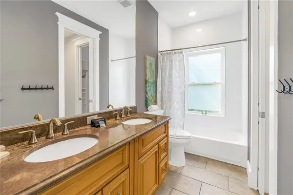 a bathroom with a double vanity sink and a mirror