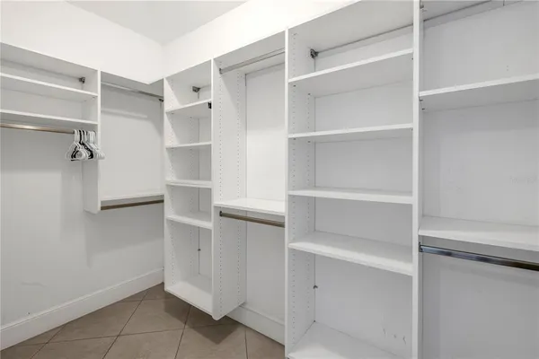 a view of walk in closet with empty racks