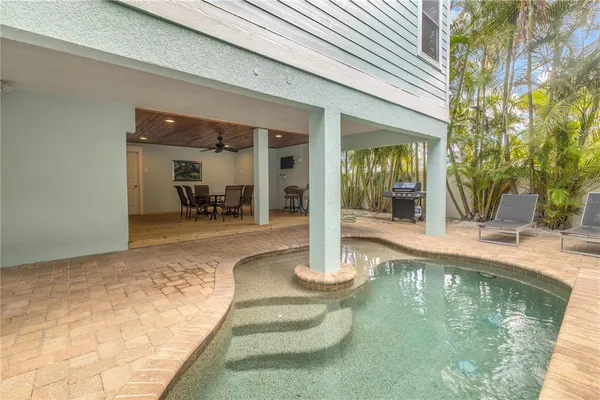 a swimming pool with outdoor seating