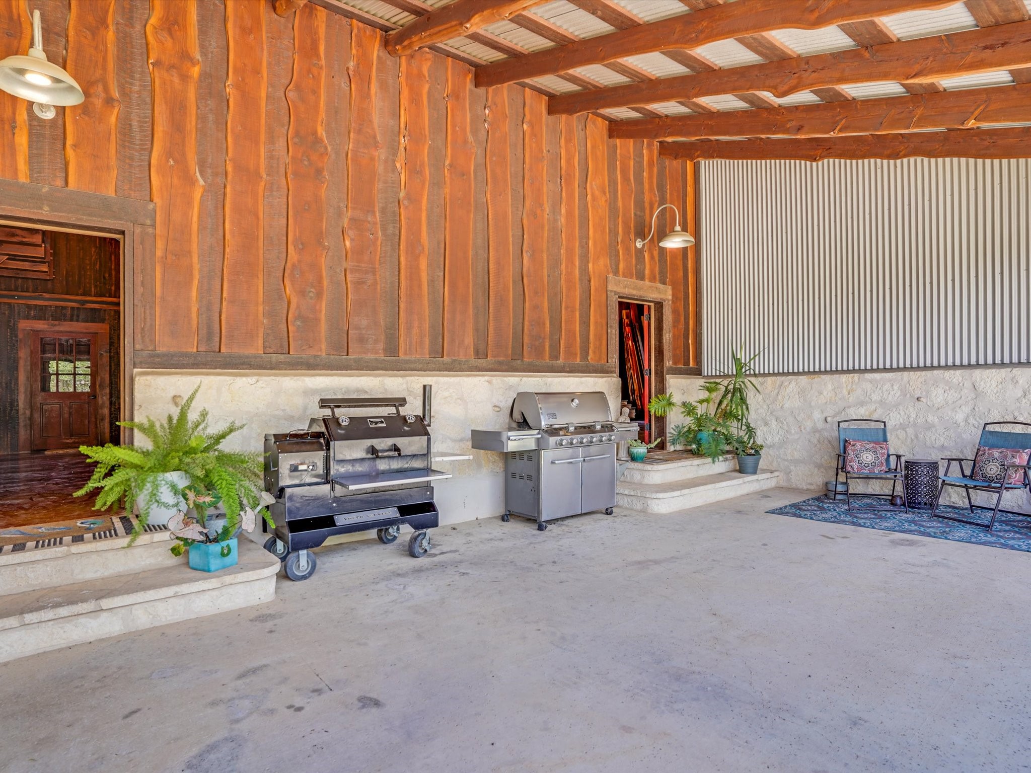 453 Lone Man Mountain Road Wimberley, TX 78676 - Photo 6 of 39 a living room with furniture a fireplace and a potted plant