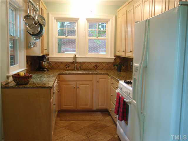 304 Brooks Avenue Raleigh, NC 27607 - Photo 7 of 14 New cabinets and granite counter. Gas range. New windows. Kitchen