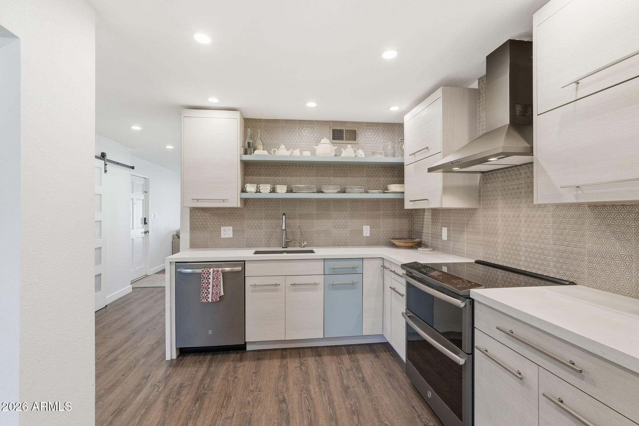 4201 East Camelback Road, Unit 34 Phoenix, AZ 85018 - Photo 3 of 19 a kitchen with stainless steel appliances a sink cabinets and wooden floor