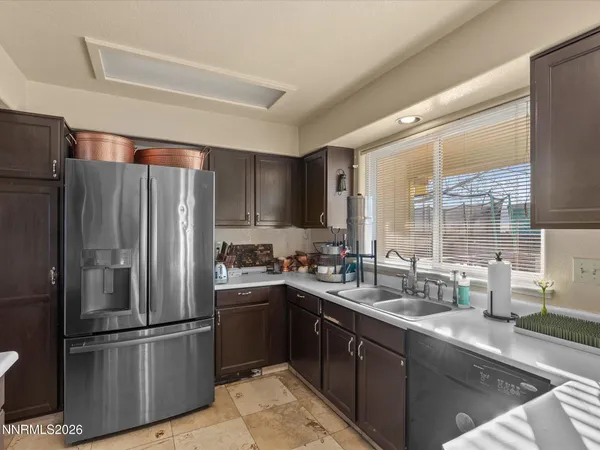 a kitchen with refrigerator and cabinets