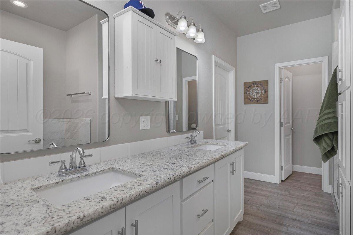 39 Cm Lane Canyon, TX 79015 - Photo 13 of 26 a bathroom with a granite countertop double vanity sink and mirror